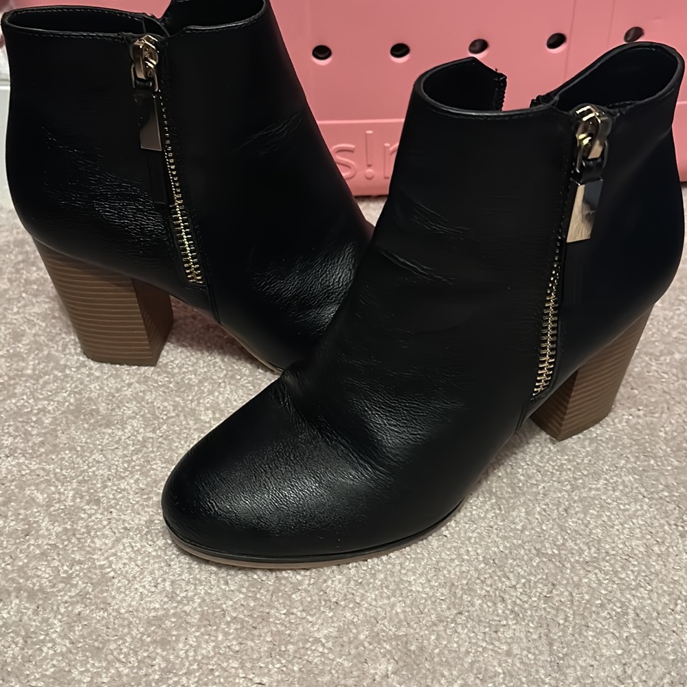 Black heed boots with gold zipper